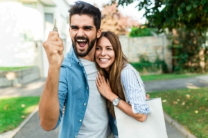 Couple holding up new house keys